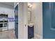Small bathroom with blue vanity, patterned floor, and modern fixtures at 975 Welch Sw St, Atlanta, GA 30310