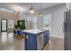 Modern kitchen with white cabinets, blue island, stainless steel appliances, and stylish backsplash at 975 Welch Sw St, Atlanta, GA 30310