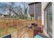 Private backyard with a wooden deck, string lights, and seating area at 975 Welch Sw St, Atlanta, GA 30310