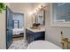 Modern bathroom with navy vanity, free-standing tub, and patterned tile floor at 975 Welch Sw St, Atlanta, GA 30310