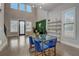Open concept living room with a glass dining table and access to an outdoor patio at 975 Welch Sw St, Atlanta, GA 30310