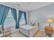 Bright bedroom featuring a comfortable bed and rocking chair at 3621 Vinings Slope Se # 3202, Atlanta, GA 30339