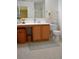 Clean bathroom with wood vanity, shower, and toilet at 1007 Sycamore Ln, Villa Rica, GA 30180