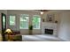 Bright living room features a fireplace, large windows, and plenty of natural light at 1007 Sycamore Ln, Villa Rica, GA 30180