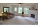 Spacious living room with a fireplace and large windows offering ample natural light at 1007 Sycamore Ln, Villa Rica, GA 30180