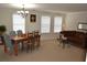 Bright dining room featuring a wood table, chairs, and large windows at 1007 Sycamore Ln, Villa Rica, GA 30180