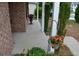 Brick front porch with flower pots and a hanging flower basket at 1007 Sycamore Ln, Villa Rica, GA 30180