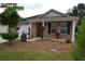 Brick ranch house with a covered porch and well-manicured landscaping at 1007 Sycamore Ln, Villa Rica, GA 30180
