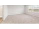 Spacious bedroom with neutral carpeting and large window at 8651 Paradise Dr, Douglasville, GA 30134