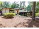 Mid-century modern home with carport and landscaped yard at 3496 Summitridge Dr, Atlanta, GA 30340