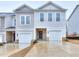 Front view of two-story townhouse with attached garage at 3401 Ripple Loop # 128, South Fulton, GA 30349