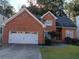 Two-story brick house with a white garage door at 360 Rams Way, Tucker, GA 30084