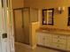 Bathroom with double vanity, shower, and frameless shower door at 360 Rams Way, Tucker, GA 30084