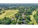 Aerial view of homes alongside a golf course and a serene lake at 2761 Major Ridge Trl, Duluth, GA 30097