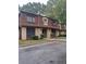 Condo building exterior, brown roof, tan siding, landscaping, and parking at 2968 Parc Lorraine, Lithonia, GA 30038