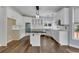 Modern white kitchen with island and stainless steel appliances at 1463 Edgemont Pt, Lawrenceville, GA 30044