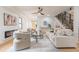 Inviting living room with fireplace, large couch, ceiling fan, and wooden staircase at 3840 Wieuca Ne Ter, Atlanta, GA 30342