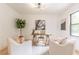 Home office with a wooden desk, two armchairs, decorative accents, and natural light at 3840 Wieuca Ne Ter, Atlanta, GA 30342