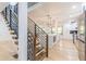 Modern wood and metal staircase leading to the second floor, overlooking the bright, open-concept kitchen at 3840 Wieuca Ne Ter, Atlanta, GA 30342