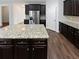 Granite kitchen island with dark wood cabinets and seating at 368 Madison Grace Ave, Mcdonough, GA 30252
