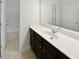 Bathroom with dark vanity, single sink, and shower/tub combo at 368 Madison Grace Ave, Mcdonough, GA 30252