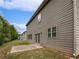 Side view of the house showing gray siding, patio, and landscaping at 368 Madison Grace Ave, Mcdonough, GA 30252