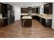 Modern kitchen with dark cabinets, granite counters, and stainless steel appliances at 368 Madison Grace Ave, Mcdonough, GA 30252