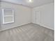 Spacious bedroom with grey carpet and window at 368 Madison Grace Ave, Mcdonough, GA 30252