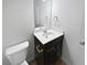 Clean bathroom with dark vanity and a single sink at 368 Madison Grace Ave, Mcdonough, GA 30252