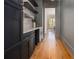 Butlers pantry with dark cabinetry, quartz countertops, and hardwood floors at 2731 Ridgewood Nw Rd, Atlanta, GA 30327