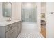 Elegant bathroom with gray tile, white bathtub, and marble vanity at 2731 Ridgewood Nw Rd, Atlanta, GA 30327