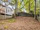 Wooded backyard with a sloped terrain, offering privacy and a natural setting at 1073 Boston Rdg, Woodstock, GA 30189