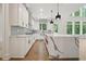 Modern kitchen with white cabinets and a large quartz island at 3930 Clifton Hill Ct, Cumming, GA 30040