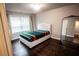 Cozy bedroom with hardwood floors and a white upholstered bed at 141 Laurel Crest Aly, Johns Creek, GA 30024