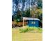 Charming blue shed with a covered porch, perfect for storage at 2696 Eldorado Pl, Snellville, GA 30078