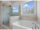 Spa-like bathroom with soaking tub and walk-in shower at 6300 Misty Hill Ln, Buford, GA 30518