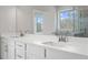 Double vanity bathroom with large mirrors and modern fixtures at 6300 Misty Hill Ln, Buford, GA 30518