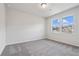 Well-lit bedroom with grey carpet and two windows at 6300 Misty Hill Ln, Buford, GA 30518