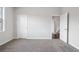 Bedroom with carpet, neutral walls, and access to other rooms at 6300 Misty Hill Ln, Buford, GA 30518