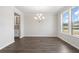 Dining room with hardwood floors, chandelier, and window views at 6300 Misty Hill Ln, Buford, GA 30518