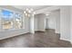 Bright dining room with hardwood floors, chandelier, and access to kitchen at 6300 Misty Hill Ln, Buford, GA 30518