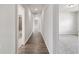 Long hallway with light walls and wood-look flooring at 6300 Misty Hill Ln, Buford, GA 30518