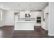 Modern white kitchen with large island and stainless steel appliances at 6300 Misty Hill Ln, Buford, GA 30518