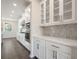 White kitchen with stainless steel appliances and quartz countertops at 6300 Misty Hill Ln, Buford, GA 30518