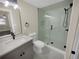 Modern bathroom with gray vanity, frameless shower, and marble floors at 1955 S Columbia Pl, Decatur, GA 30032