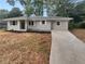 Newly renovated house with light gray siding and a long driveway at 1955 S Columbia Pl, Decatur, GA 30032