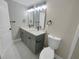 Updated bathroom with double vanity, modern fixtures, and a gray cabinet at 1955 S Columbia Pl, Decatur, GA 30032