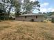 Large backyard with a mostly bare lawn and trees around at 1955 S Columbia Pl, Decatur, GA 30032