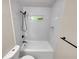 Updated bathroom with a tub and shower, modern fixtures and white tile at 1955 S Columbia Pl, Decatur, GA 30032