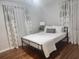 Bedroom with a queen bed, desk, and patterned curtains at 3242 Bonway Dr, Decatur, GA 30032